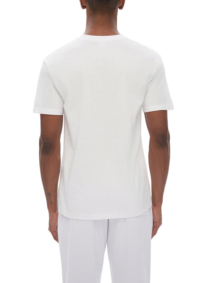 Person wearing a plain white t-shirt and pants on a white background