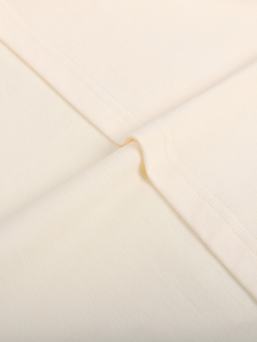 Close-up of a beige envelope with a gold flap