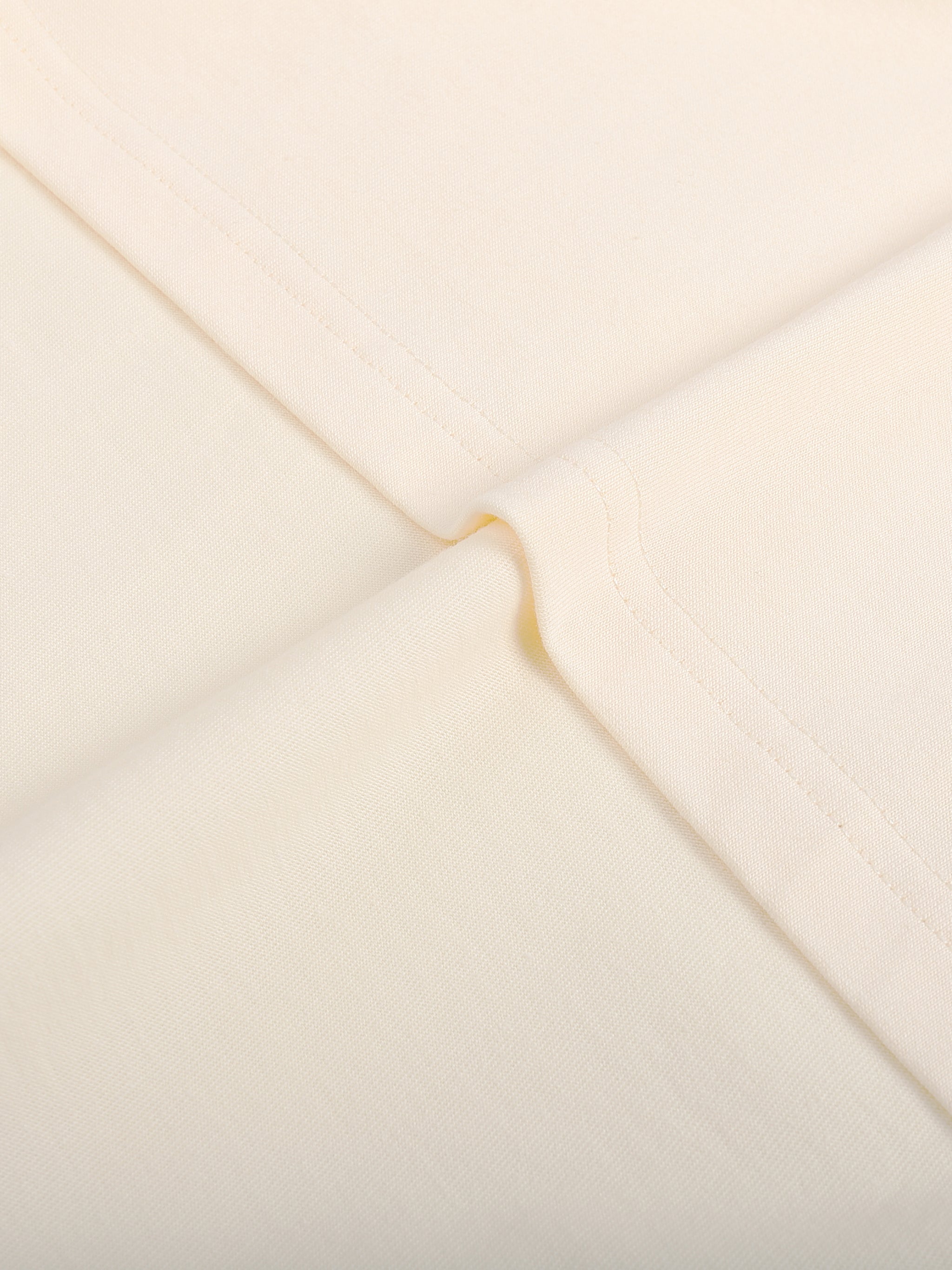 Close-up of a beige envelope with a gold flap
