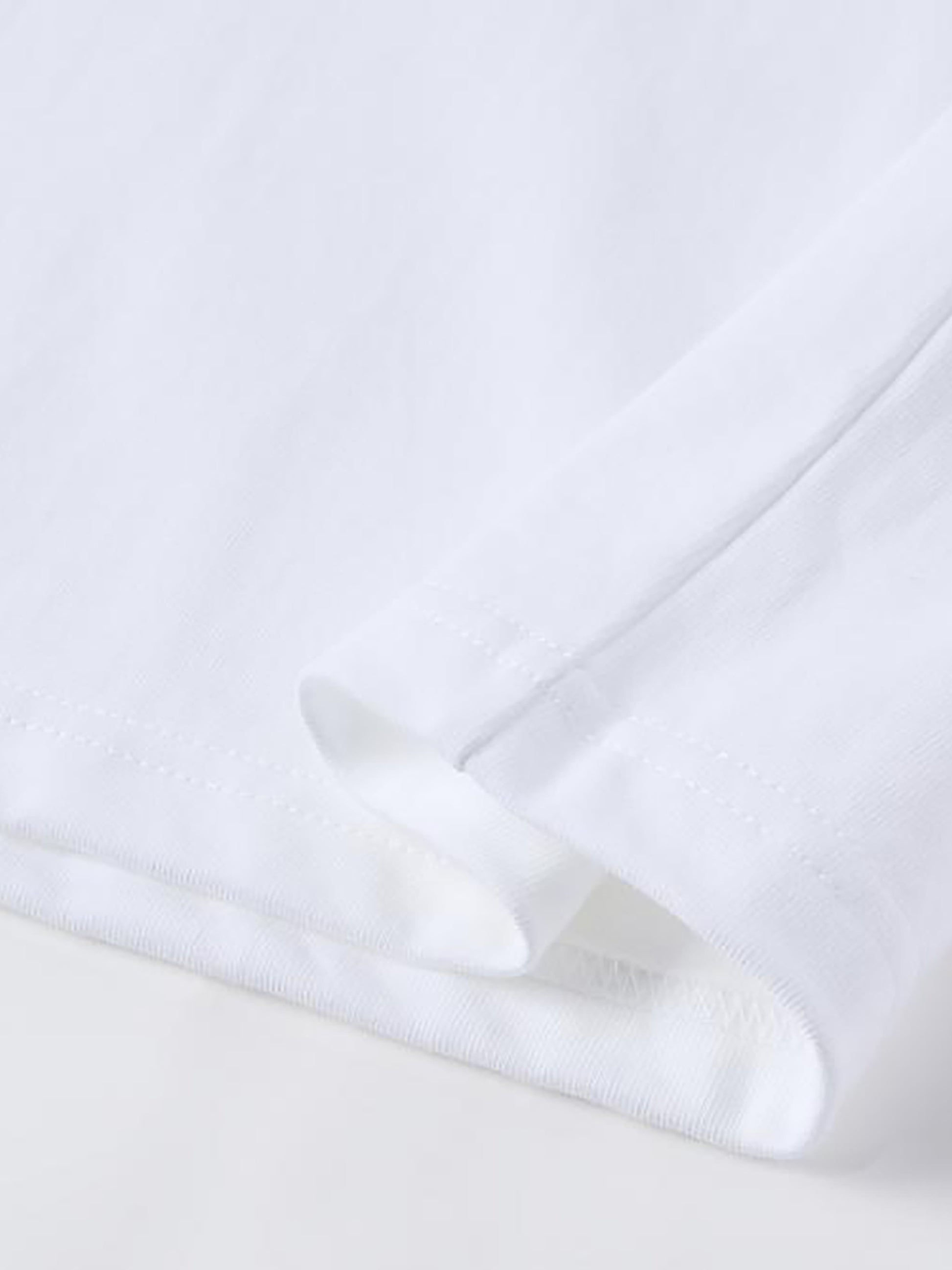 Close-up of a white shirt with a collar on a light gray background