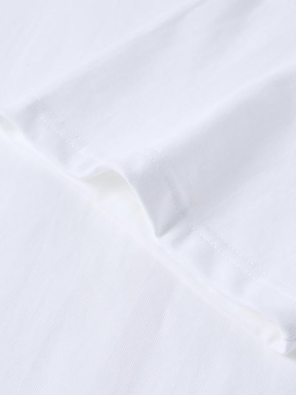 Close-up of a white shirt with a collar on a light gray background