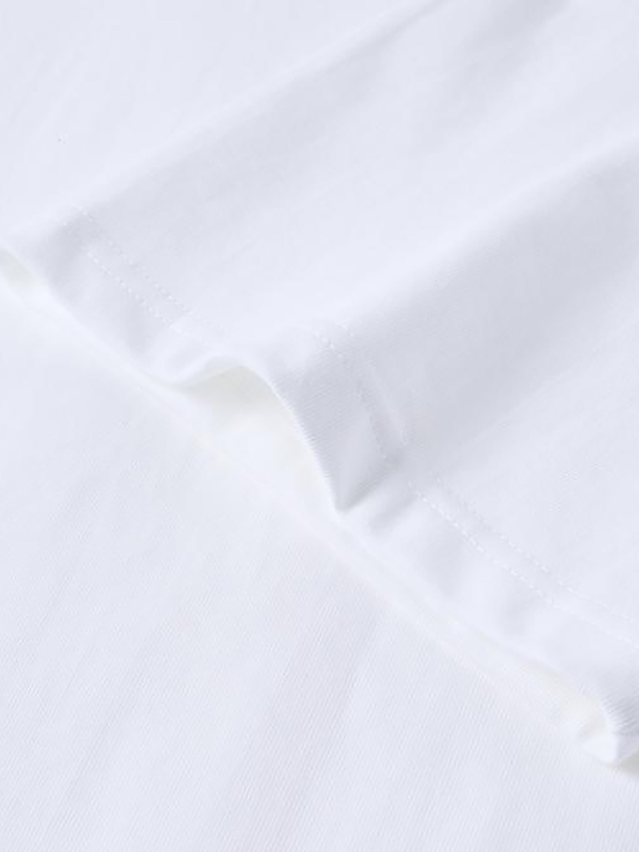 Close-up of a white shirt with a collar on a light gray background