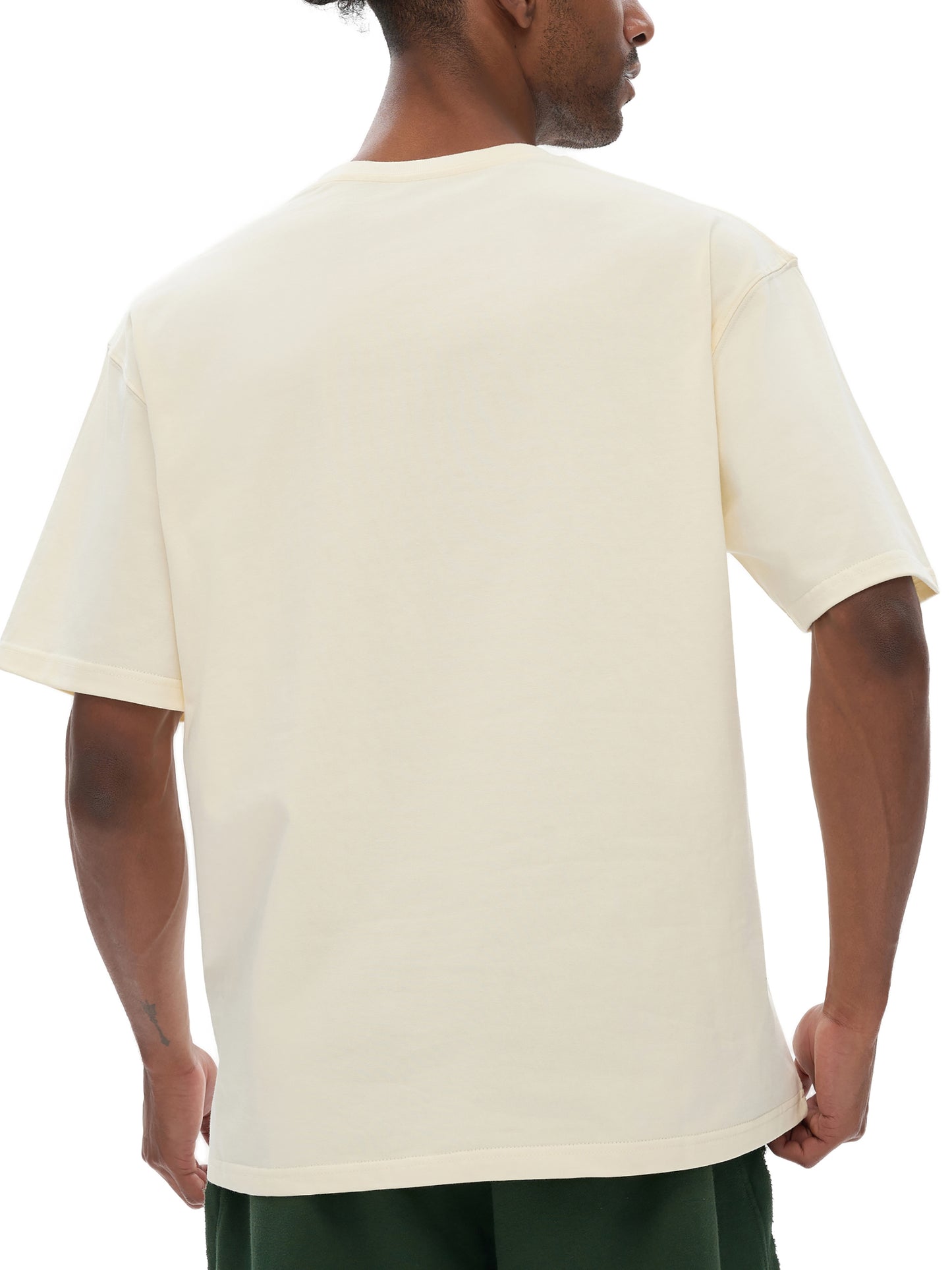 Person wearing a VERON beige t-shirt on a white background