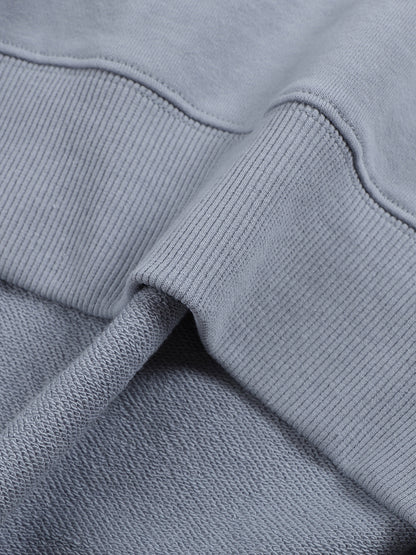 Close-up of a gray sweatshirt with a focus on texture and stitching.