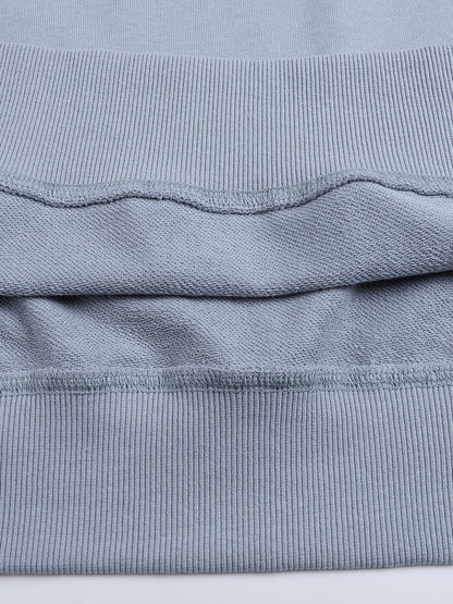 Close-up of a folded blue fabric with visible texture on a white background
