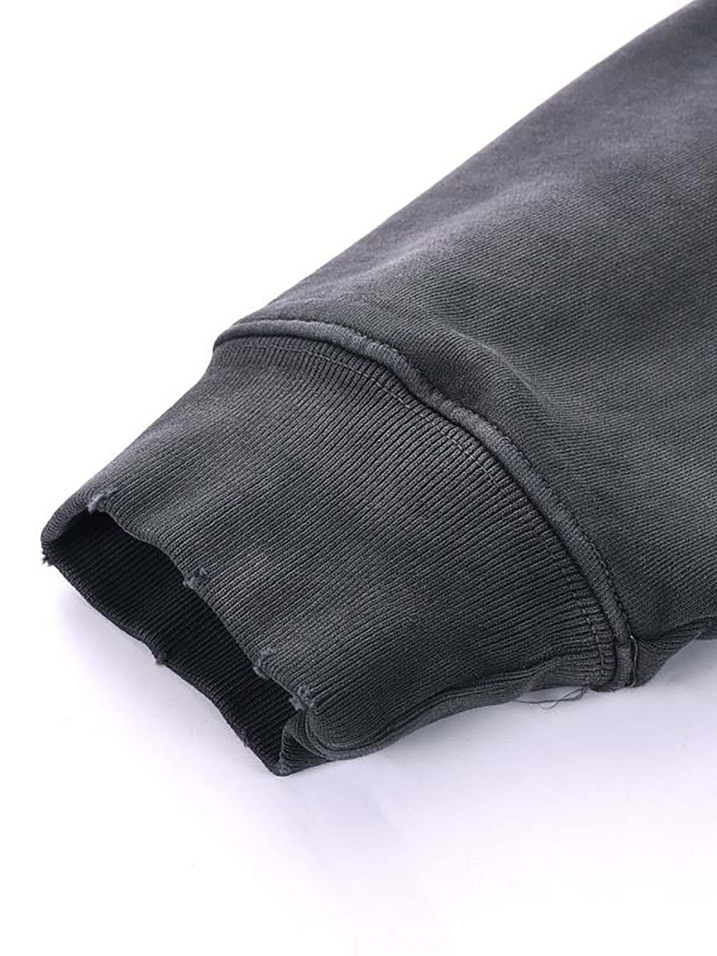 Close-up of a dark gray fabric edge on a white background