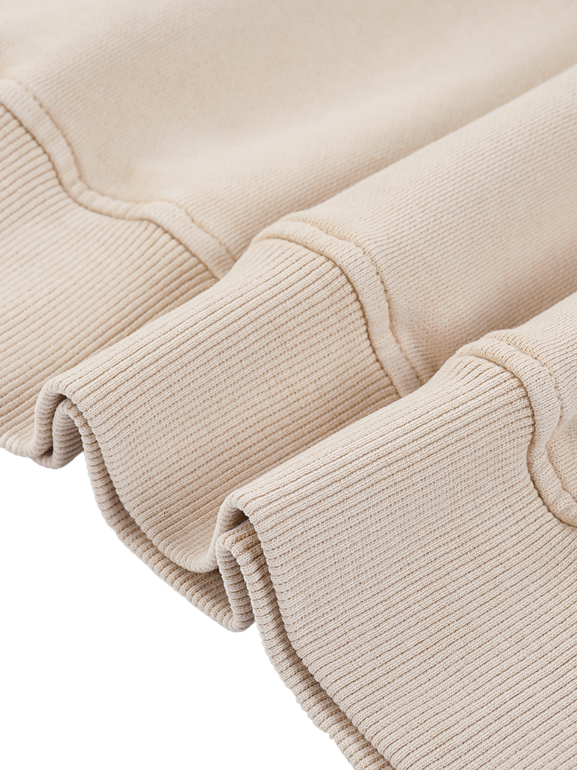 Close-up of beige knit fabric with a white background
