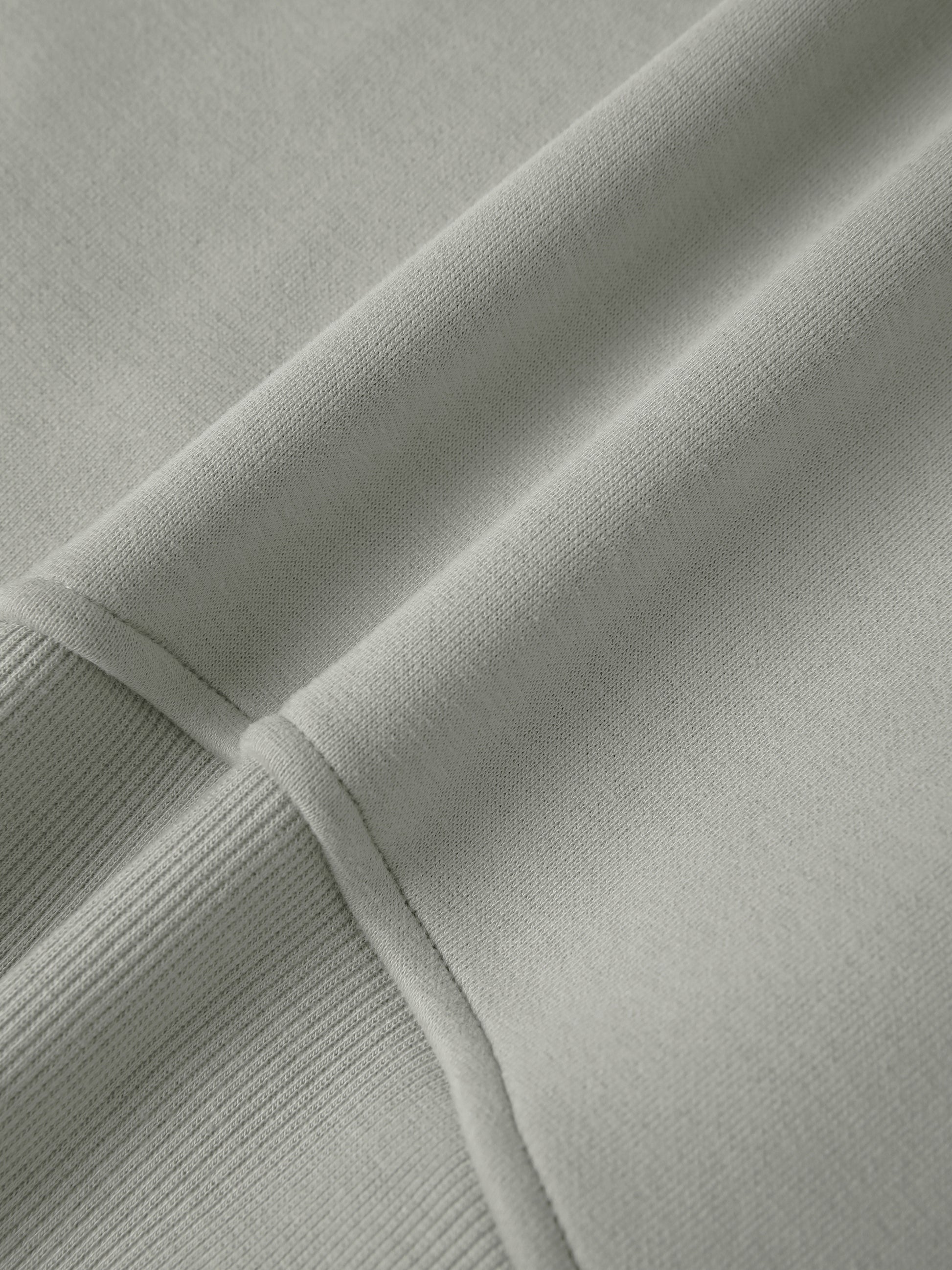 Close-up of light gray fabric with ribbed texture