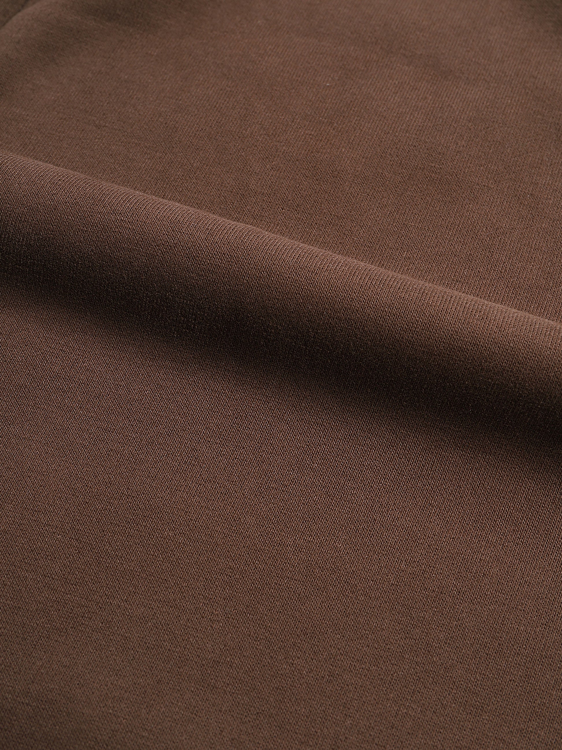 Close-up of brown fabric with a subtle texture