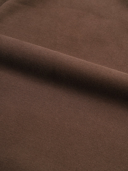 Close-up of brown fabric with a subtle texture