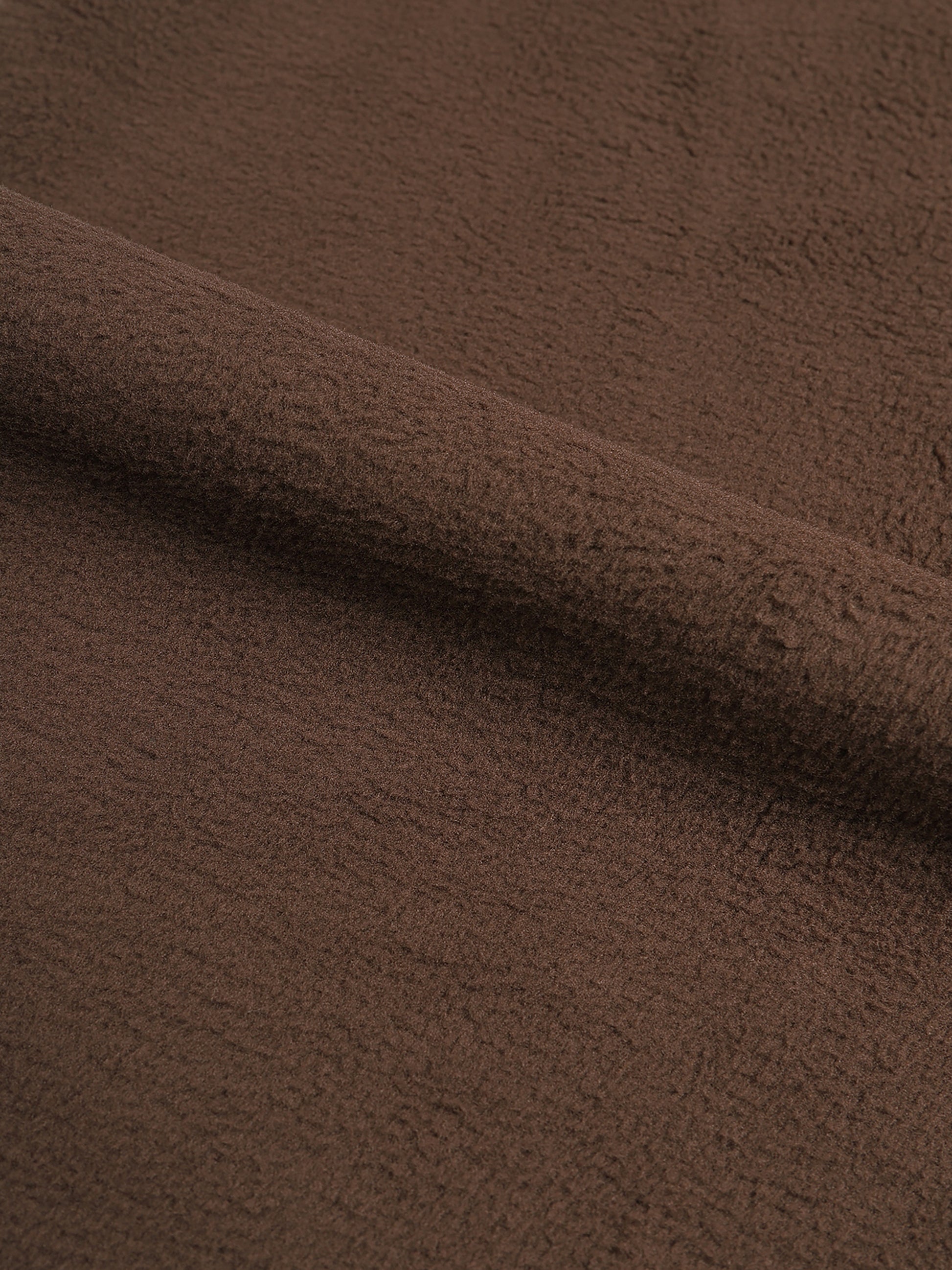 Close-up of brown fabric with a soft texture. 