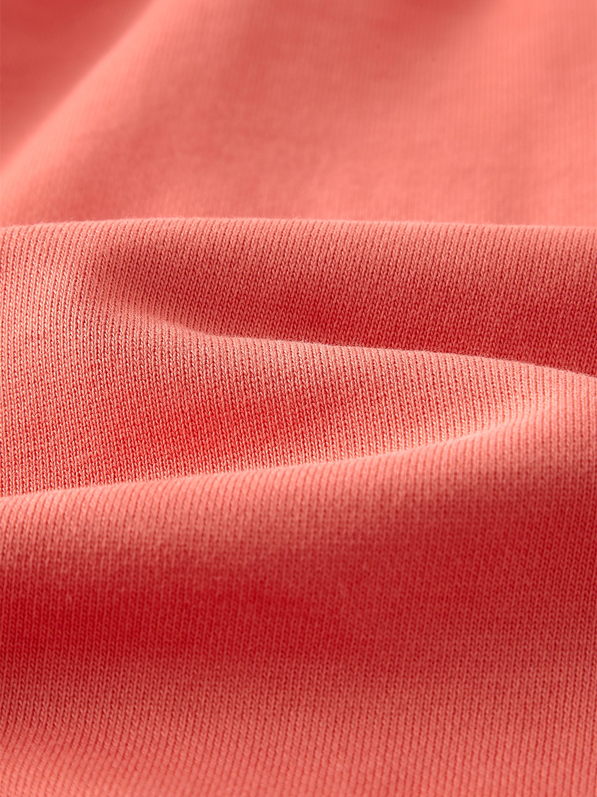 VERON Close-up of pink fabric with visible texture