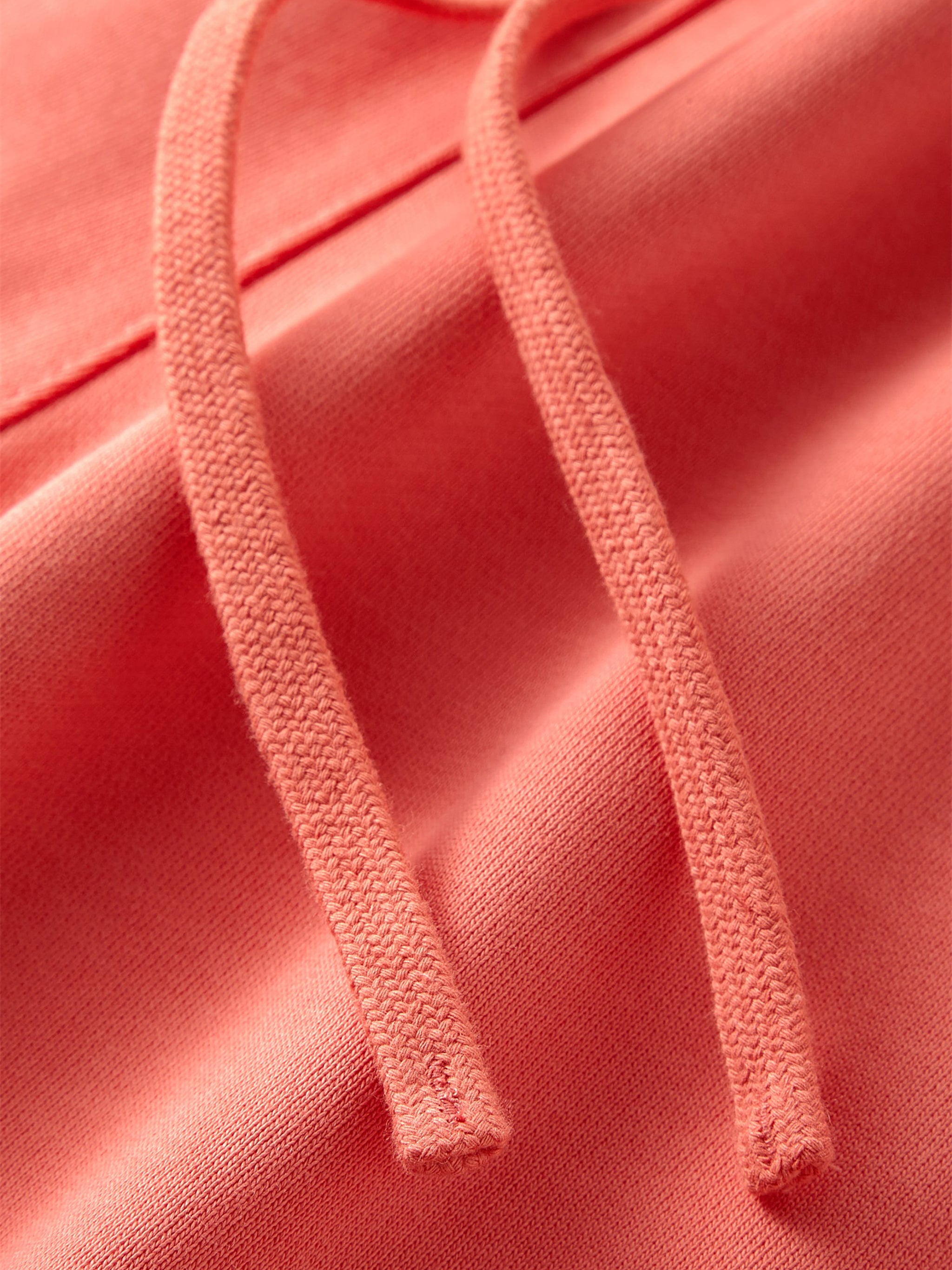 VERON Close-up of pink fabric with drawstrings on a matching pink background