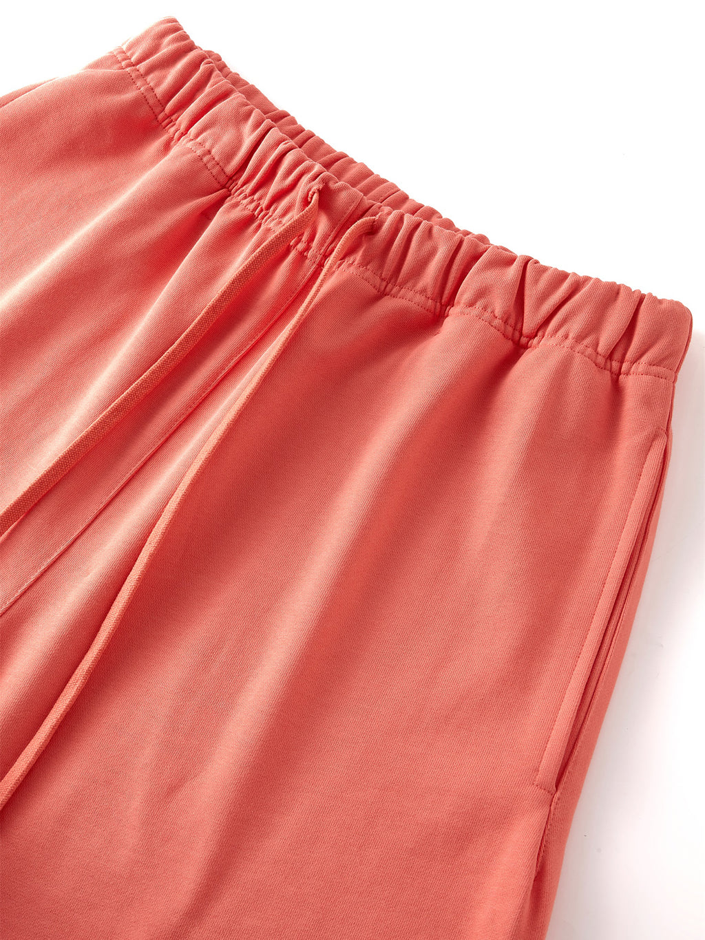 VERON Close-up of coral-colored pants on a white background