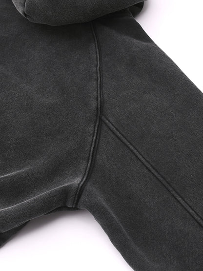 Close-up of a dark gray hoodie on a white background