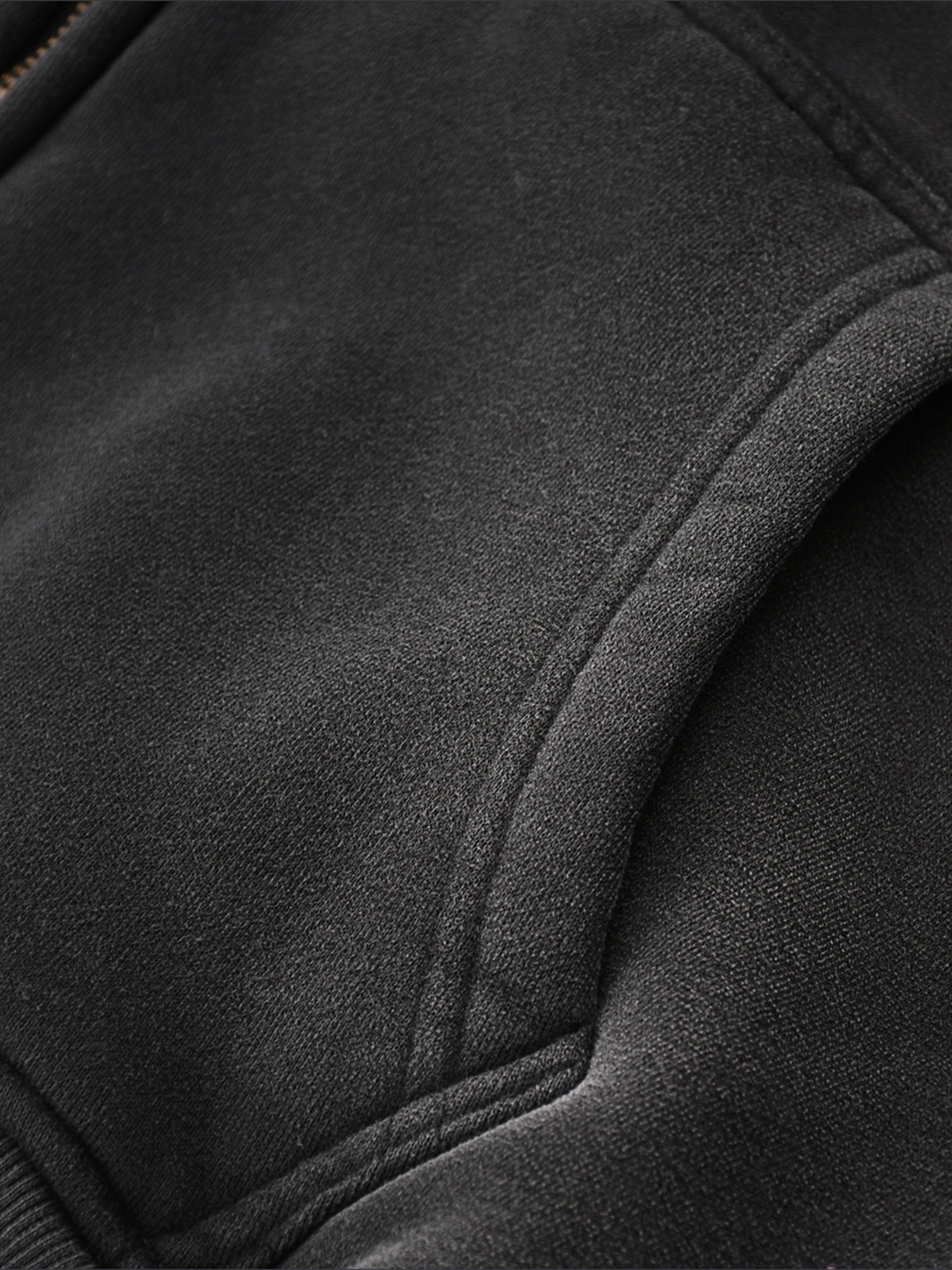 Close-up of a black jacket with a focus on texture and stitching.