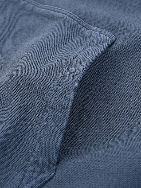 Close-up of a blue fabric texture with stitching detail