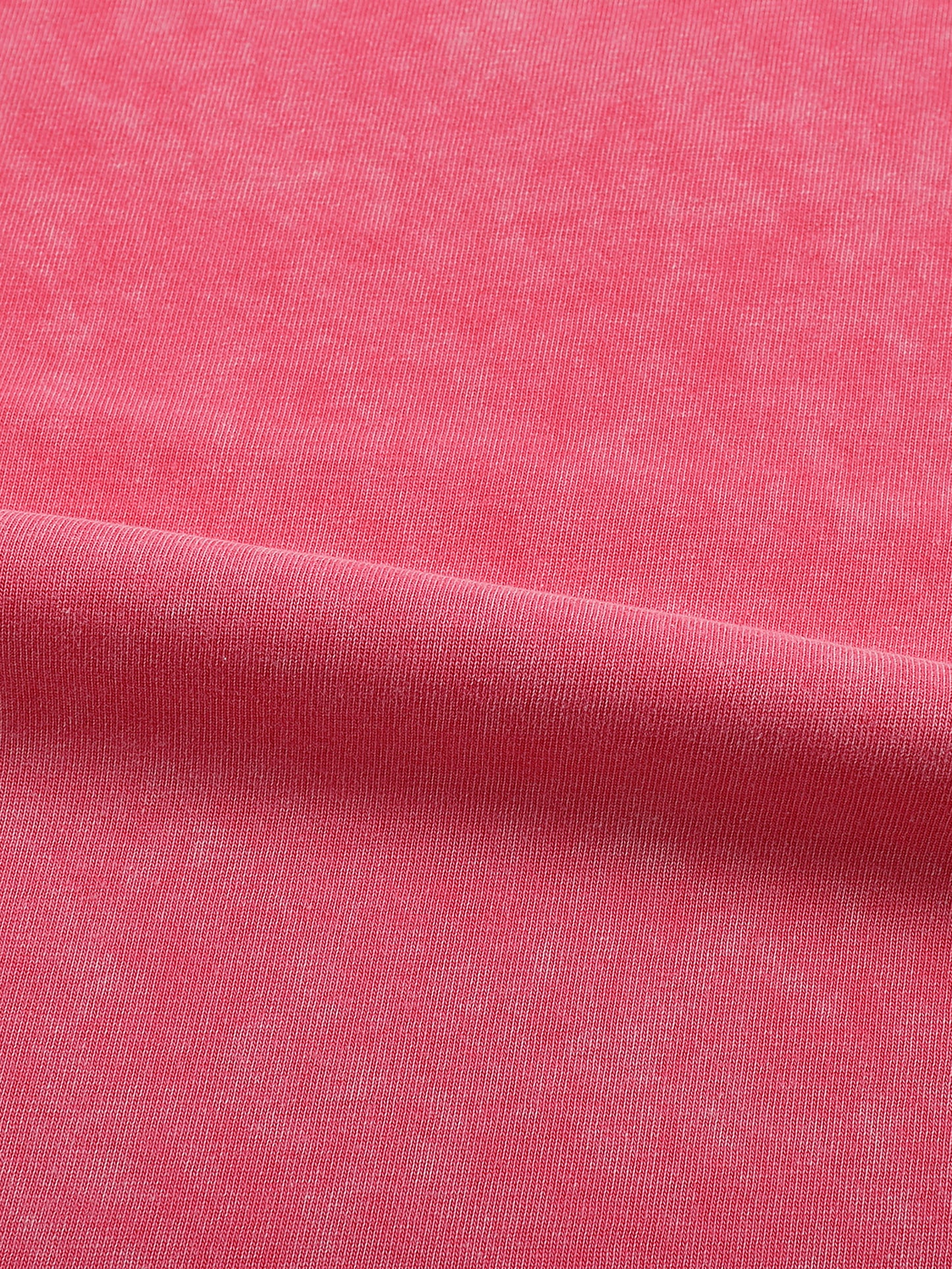 Close-up of pink fabric with a subtle texture