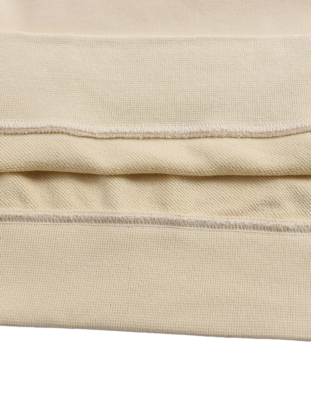 Close-up of beige fabric with visible stitching on a white background