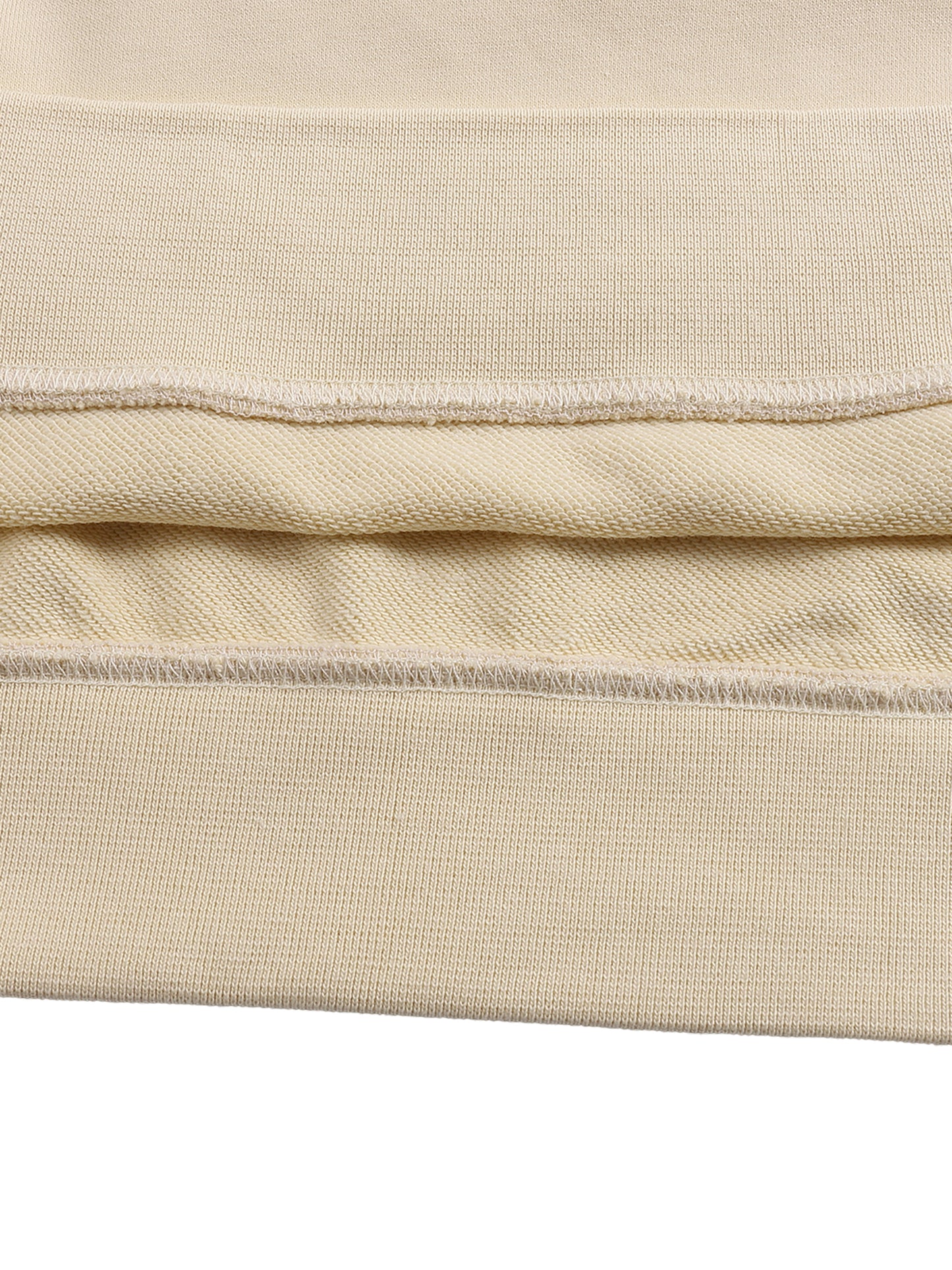 Close-up of beige fabric with visible stitching on a white background