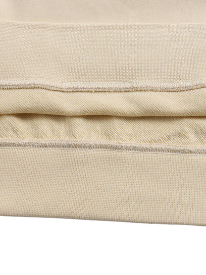 Close-up of beige fabric with visible stitching on a white background