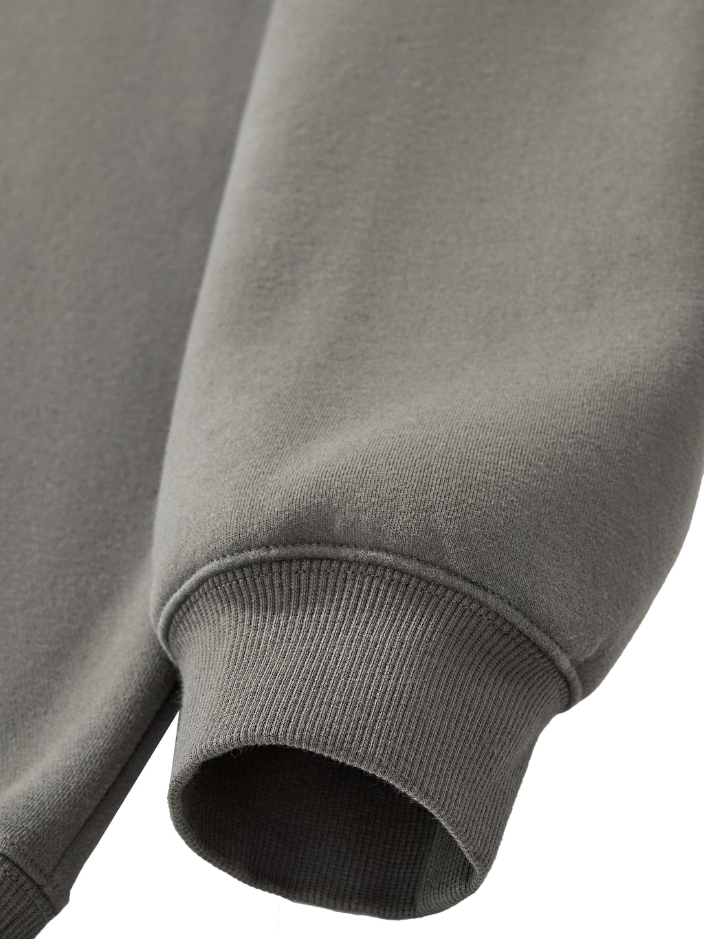 Close-up of a gray sweatshirt with a focus on the sleeve and hem.
