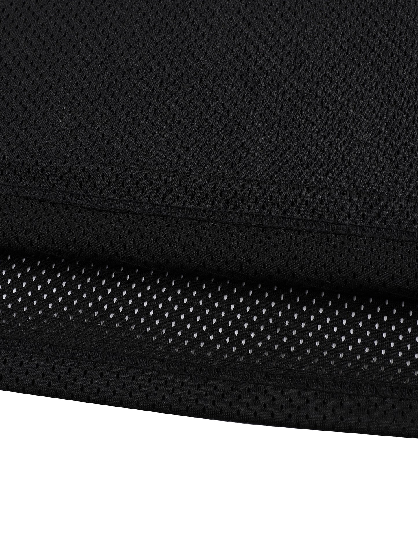 Close-up of black fabric with a textured pattern on a white background