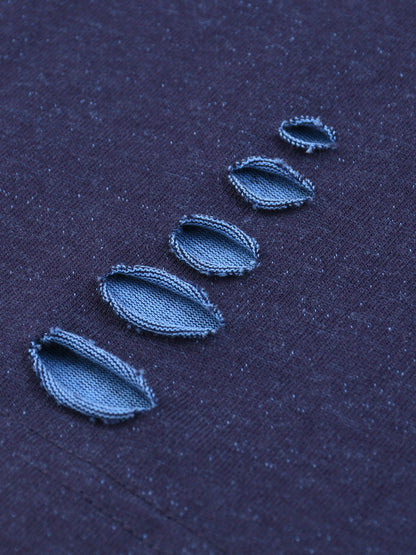 Close-up of blue embroidered leaves on a dark fabric background