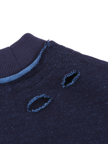 Close-up of a navy blue sweater with embroidered lips on a white background