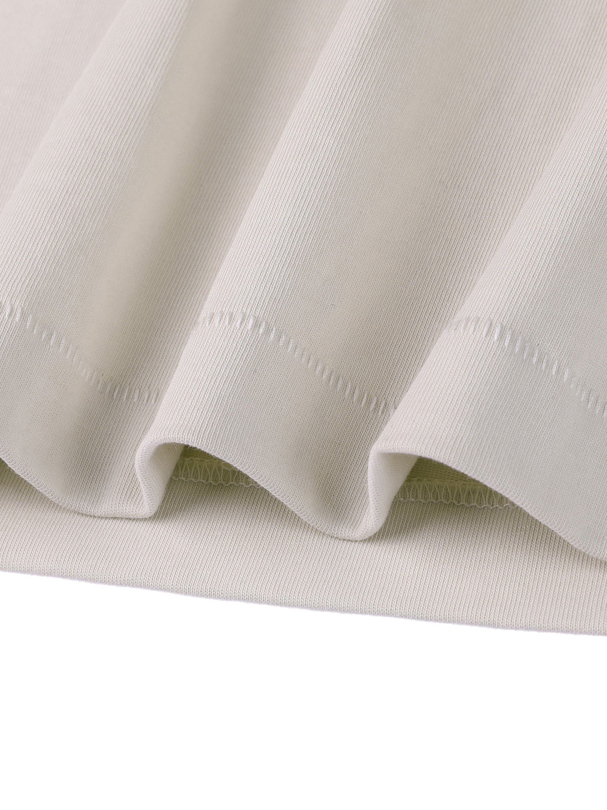 Close-up of light gray fabric with visible stitching on a white background