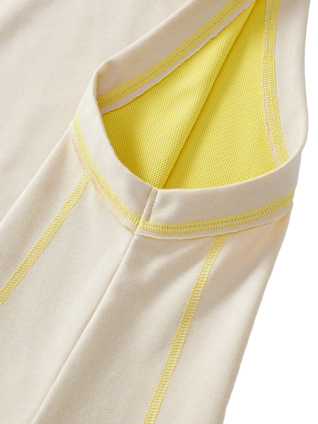 Close-up of a beige garment with yellow stitching on a white background