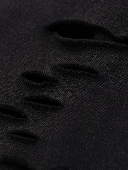 Close-up of black distressed denim fabric