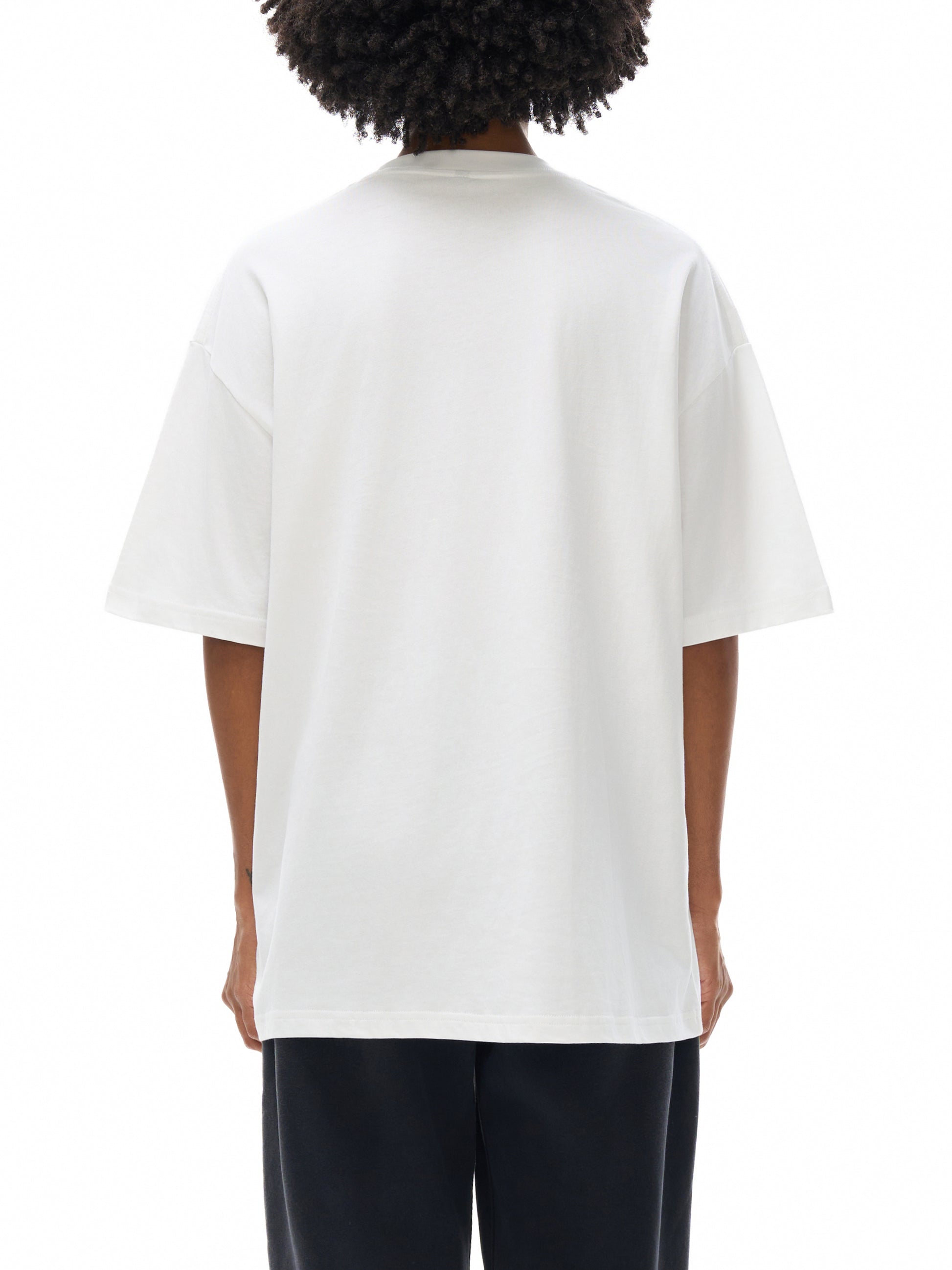 Person wearing a white t-shirt on a white background