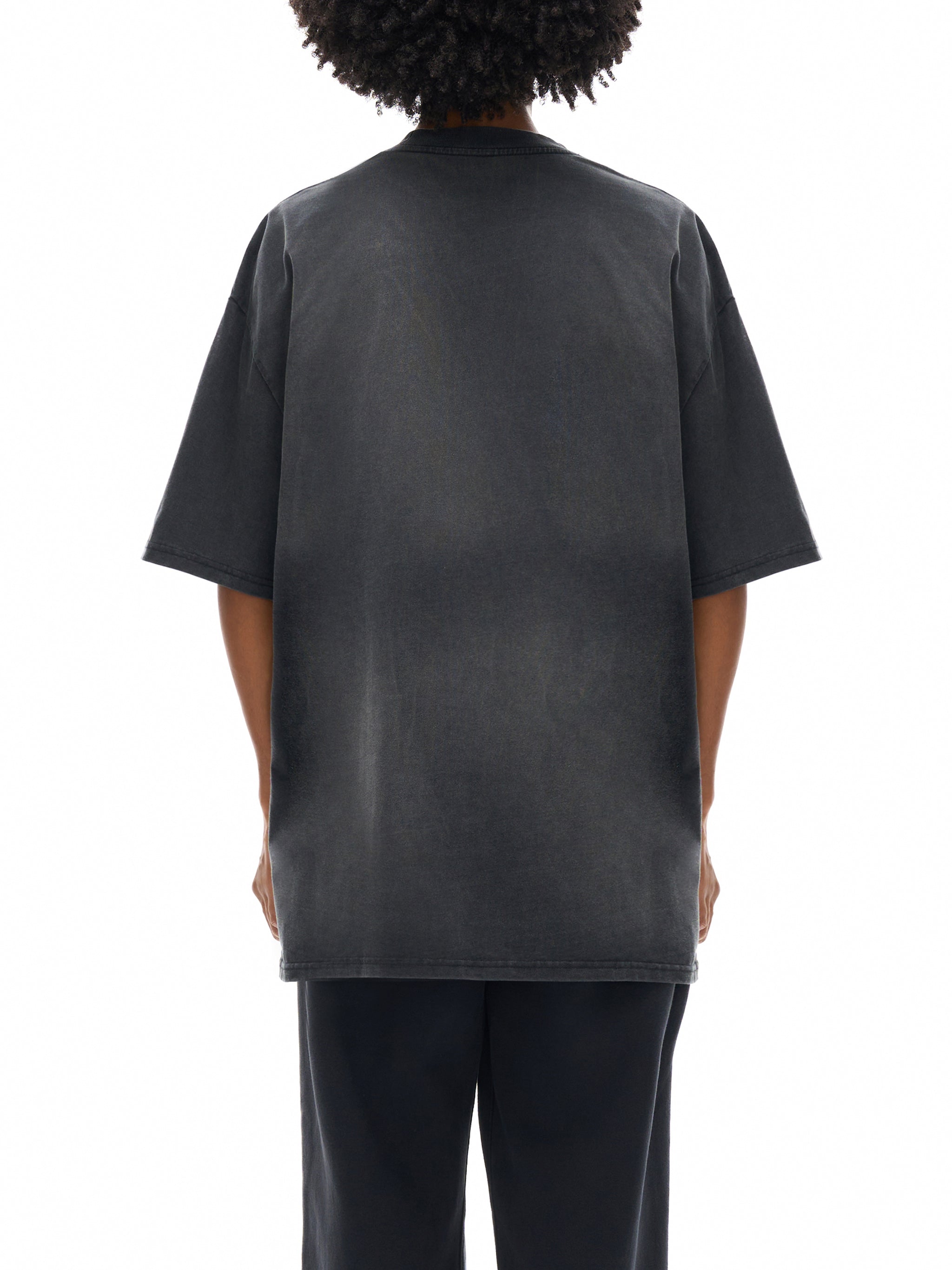 Person wearing a black t-shirt on a white background
