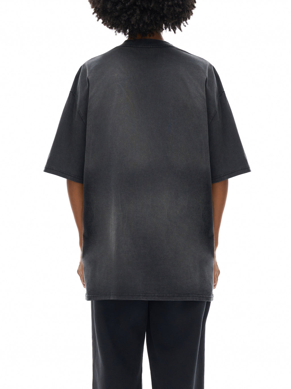 Person wearing a black t-shirt on a white background