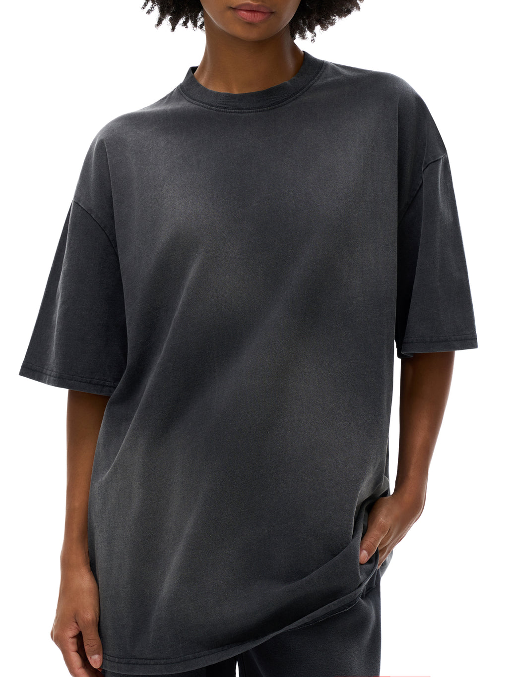 Person wearing a plain black t-shirt on a white background