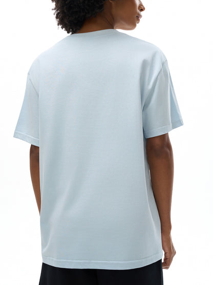 Person wearing a light blue t-shirt on a white background