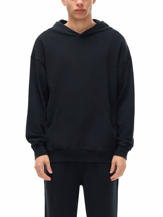 Model wearing VÉRON Louvre-inspired oversized hoodie in urban streetwear setting 1