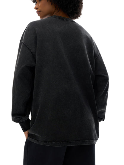Person wearing a black oversized sweatshirt on a white background