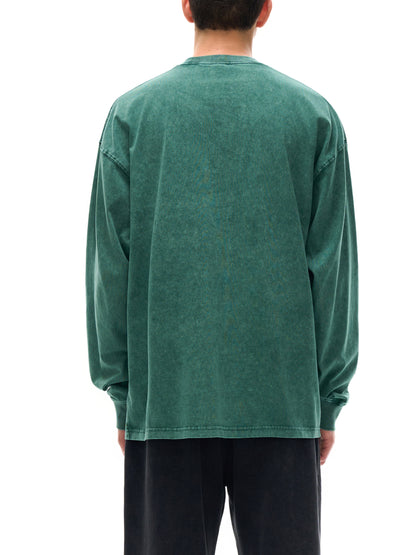 Person wearing a green long-sleeve shirt on a white background
