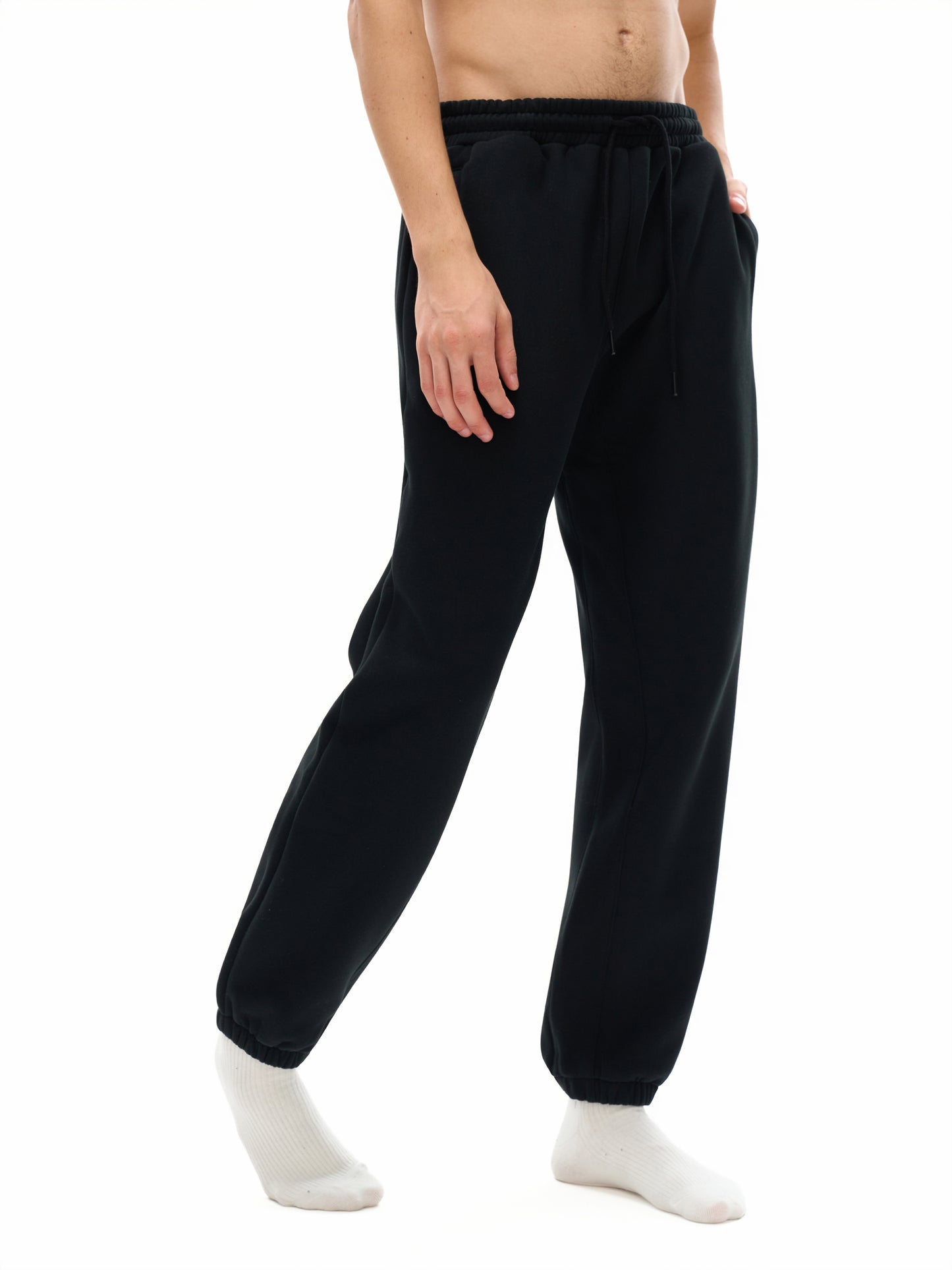 Person wearing black pants on a white background