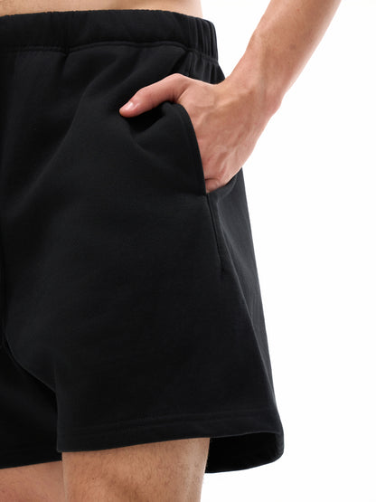 VERON Black shorts worn by a person on a white background