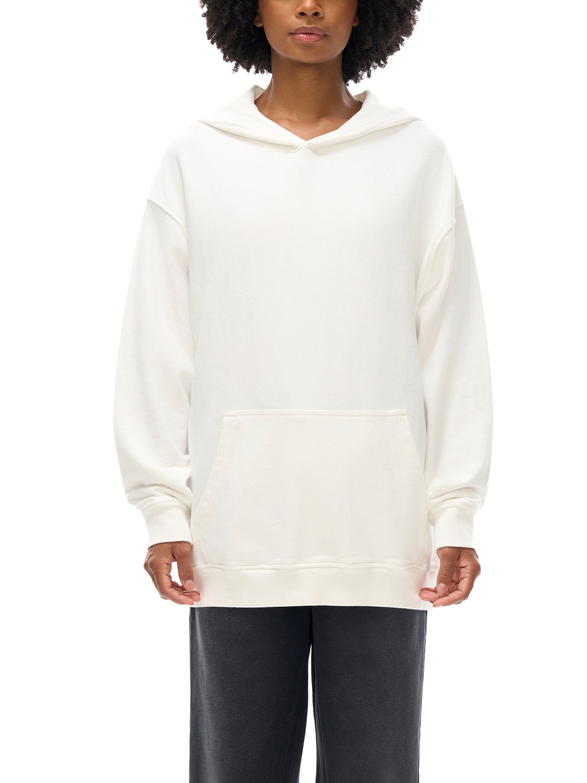 Person wearing a white hoodie on a white background