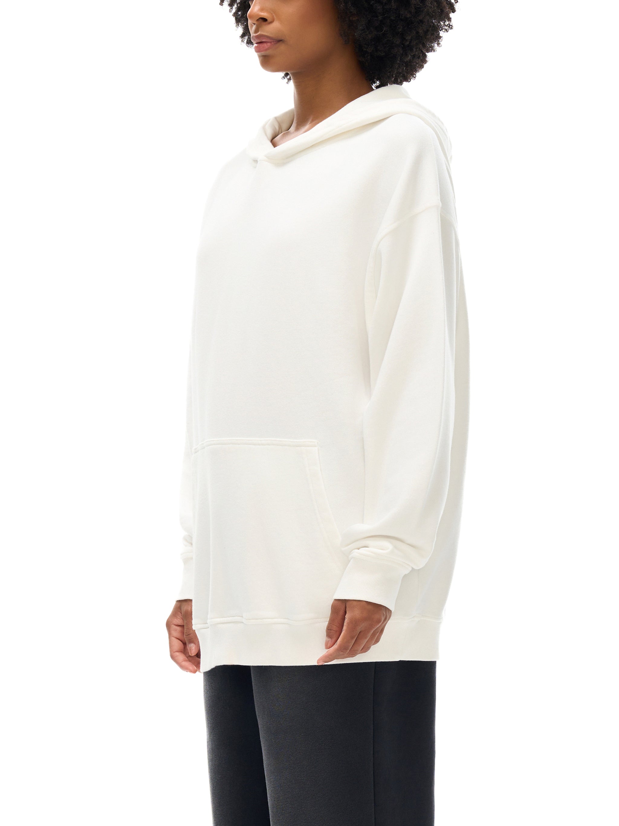 Person wearing a white hoodie on a white background