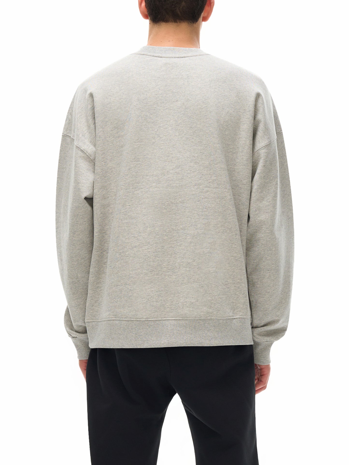 Person wearing a gray sweatshirt from behind on a white background