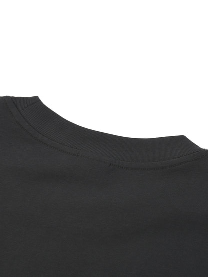 Close-up of a black t-shirt collar on a white background. 