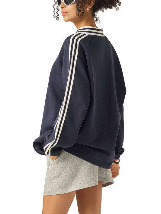 Model wearing VERON navy sweatshirt with white stripes on a white background