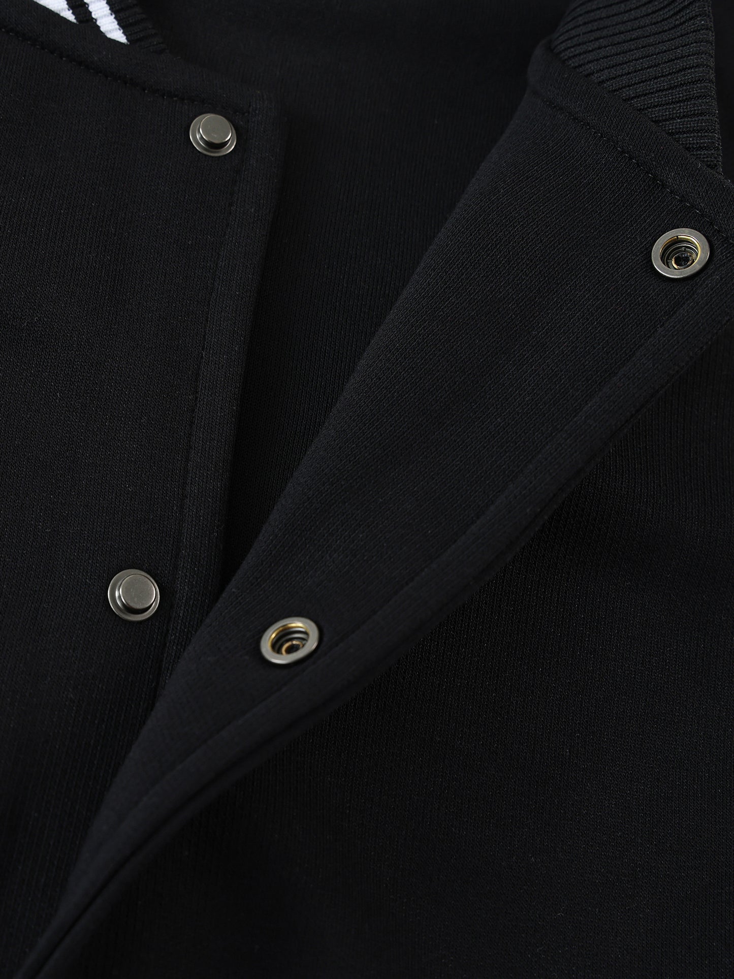 Close-up of VERON black Jacket with silver buttons