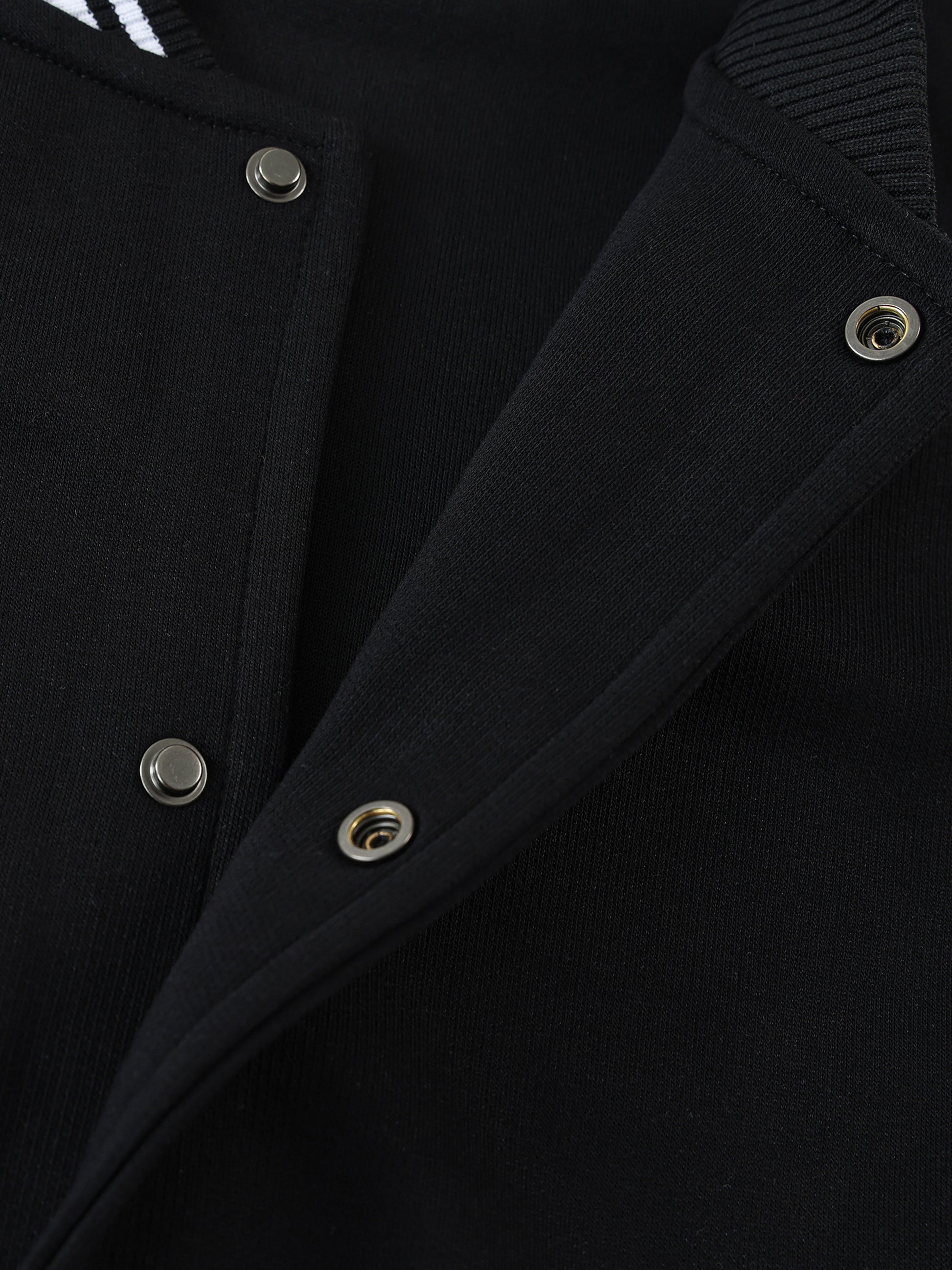 Close-up of VERON black Jacket with silver buttons