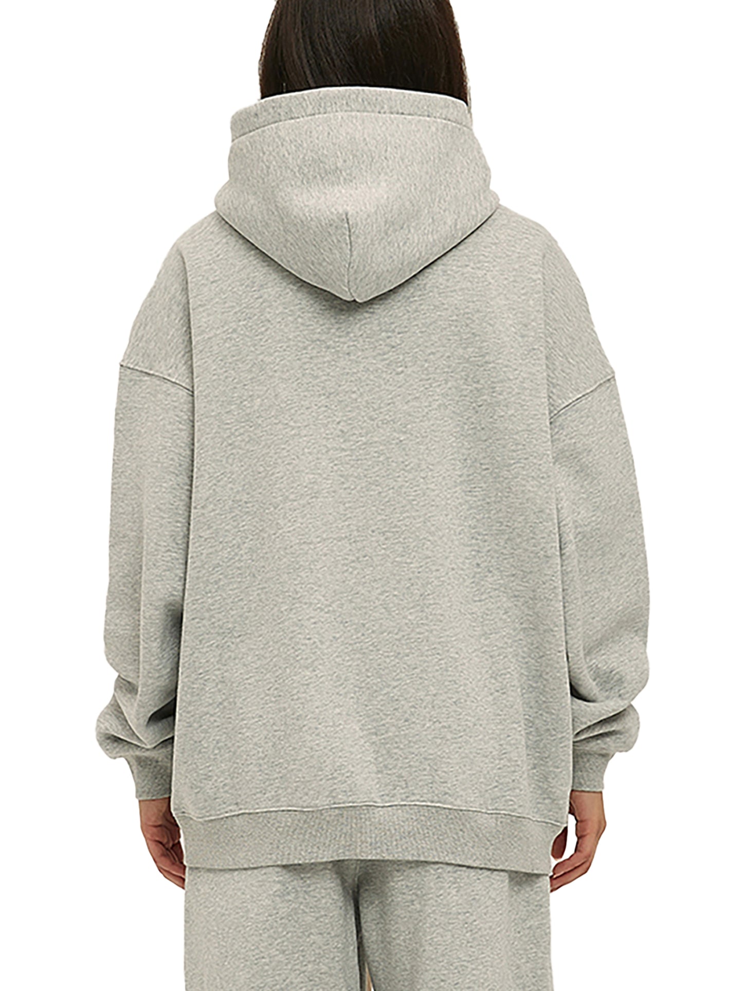 Person wearing a gray hoodie and pants on a white background